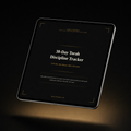 A tablet device displaying a black digital cover titled '30-Day Torah Discipline Tracker' with white and gold text, photographed on a dark background with a warm spotlight below. GXM KINGDOM