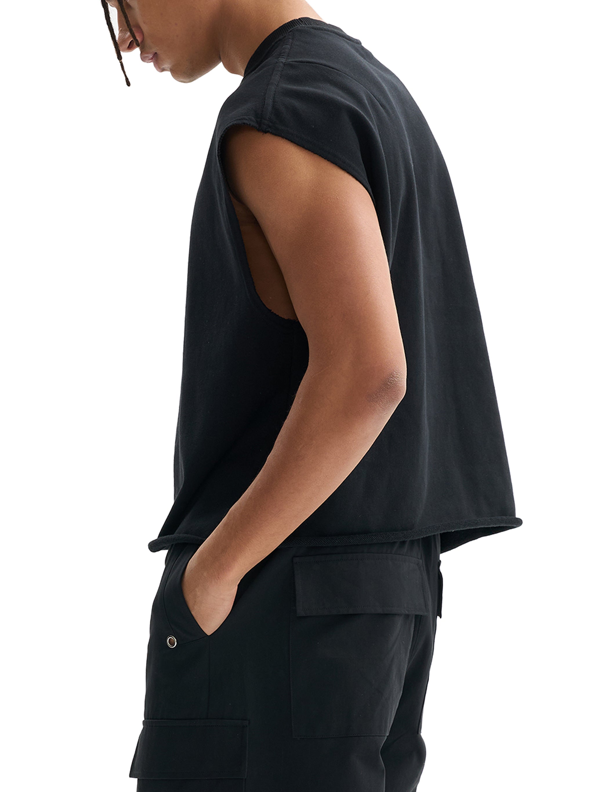 Person wearing a black sleeveless top and pants on a white background