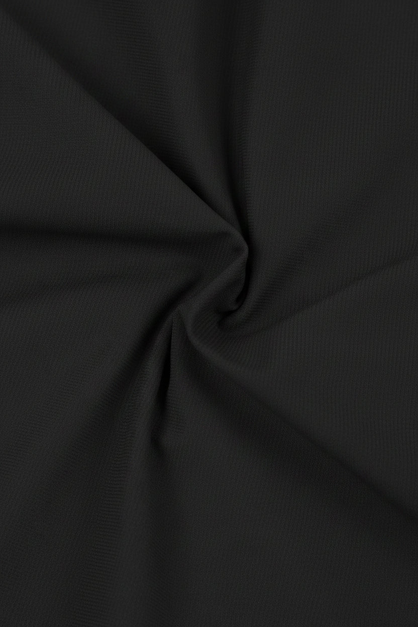 Close-up of light black fabric with folds